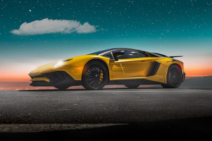 Yellow Lamborghini Aventador under starry sky
