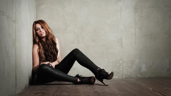 Miley Cyrus sitting in a corner