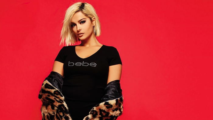 Bebe Rexha wearing a black shirt with leopard print jacket