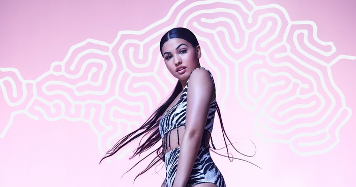 Mabel in a zebra print outfit against a pink background