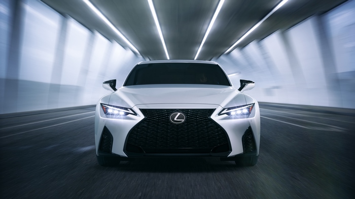 White Lexus IS driving through a tunnel