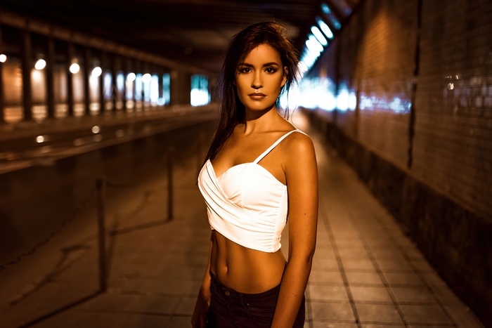 Woman in white top in tunnel