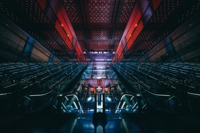 Futuristic escalator hall with red and blue lights