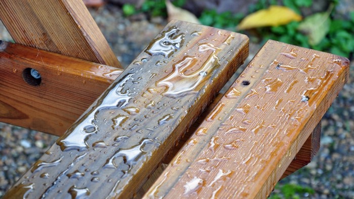 Water droplets on a wet wooden surface