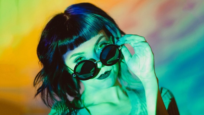 Woman with dyed hair and sunglasses