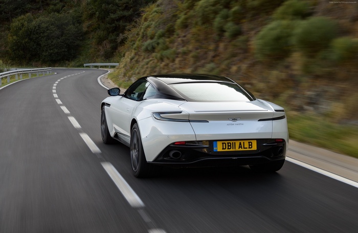 Aston Martin DB11 V8 driving on a winding road