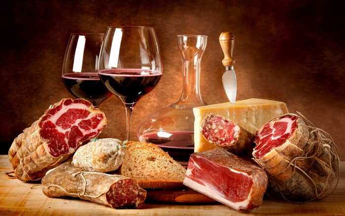 Charcuterie board with wine, cheese, and bread