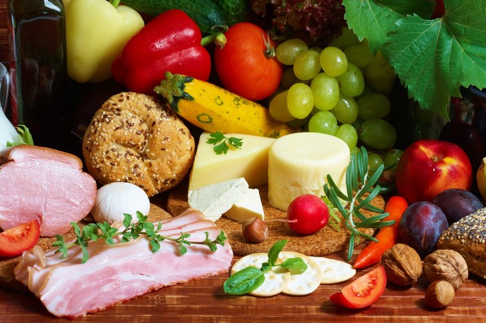 Assortment of food including meats, cheeses, fruits, and vegetables