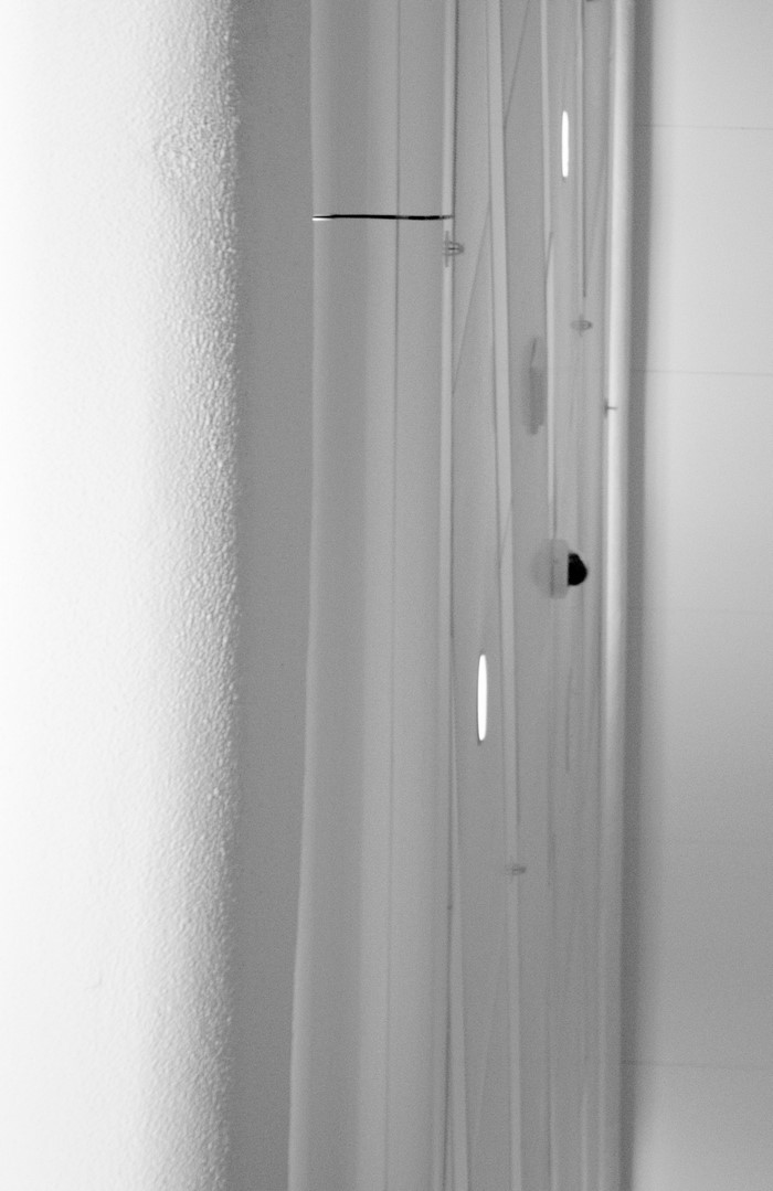 Minimalist interior with textured wall and vertical blinds