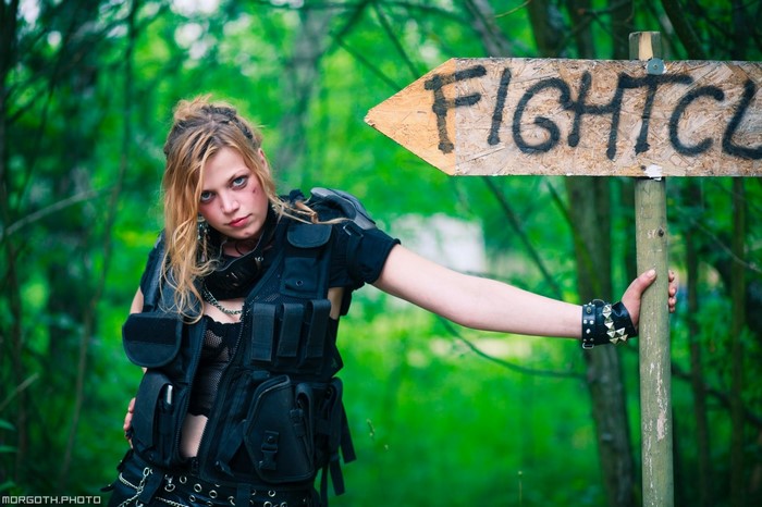 Woman in tactical gear by Fight Club sign
