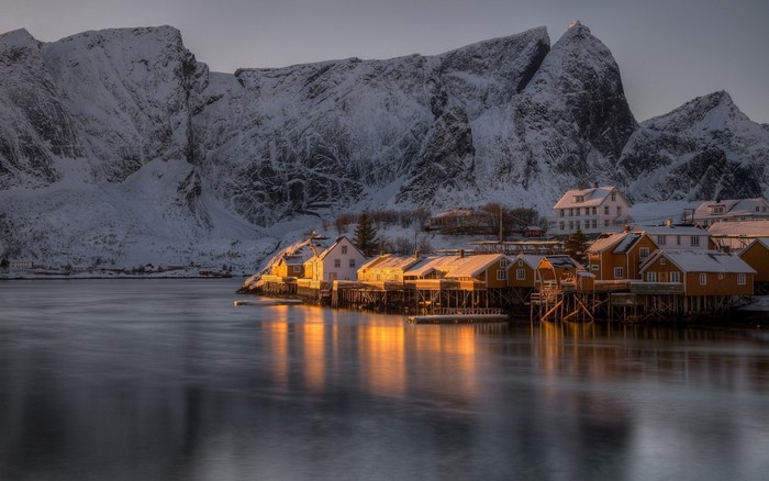 Snowy mountains and village at sunset in Lofoten, Norway