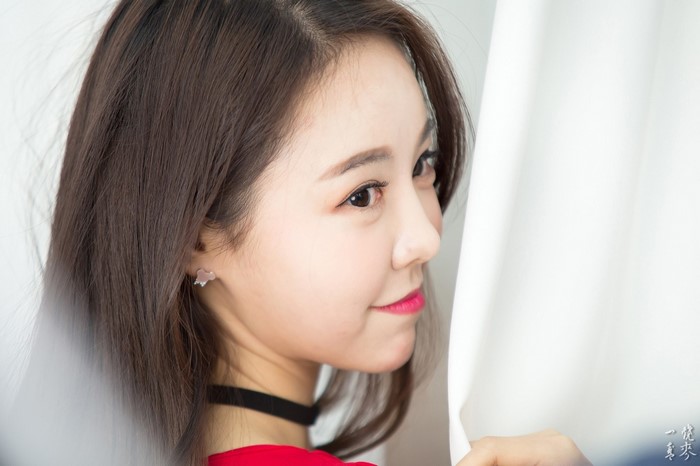 Close-up portrait of a young Asian woman with brown hair