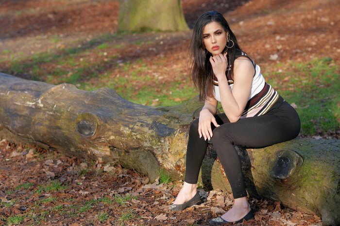 Woman sitting on a log in a forest