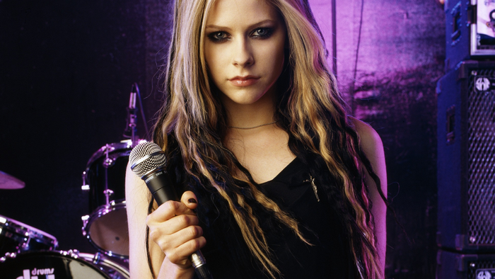 Avril Lavigne singing with a microphone
