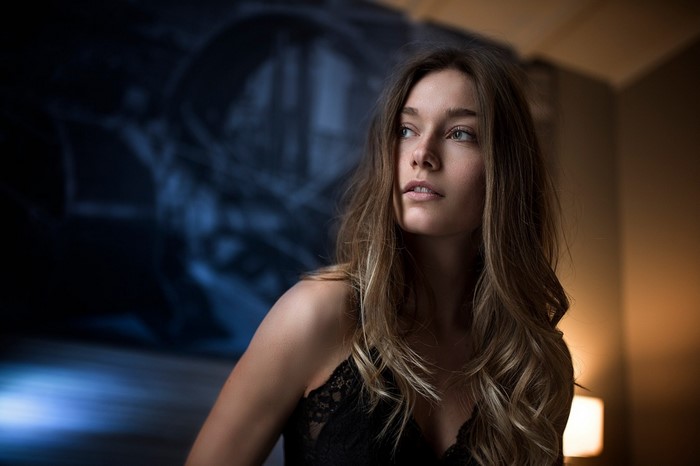 Woman with long brown hair in black lingerie