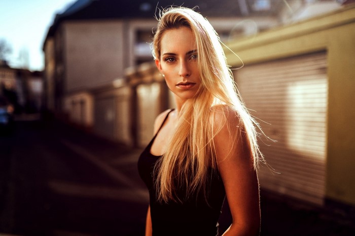 Woman with long blond hair in a black tank top