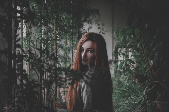 Woman with red hair in a garden