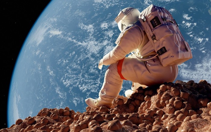 Astronaut sitting on a rocky surface overlooking Earth