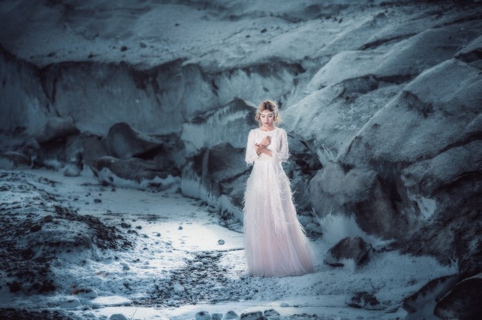 Woman in white dress in a glacial landscape