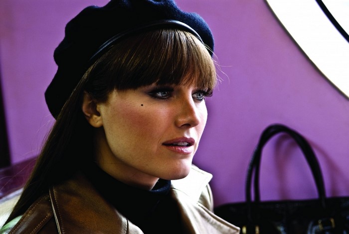 Malin Akerman wearing a black beret and leather jacket