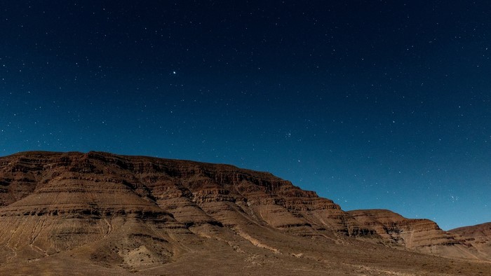 Mountain plateau under a starry night sky