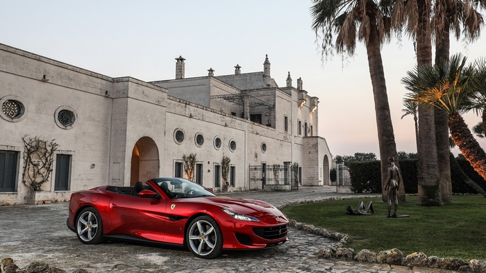 Ferrari Portofino GT parked in front of a villa