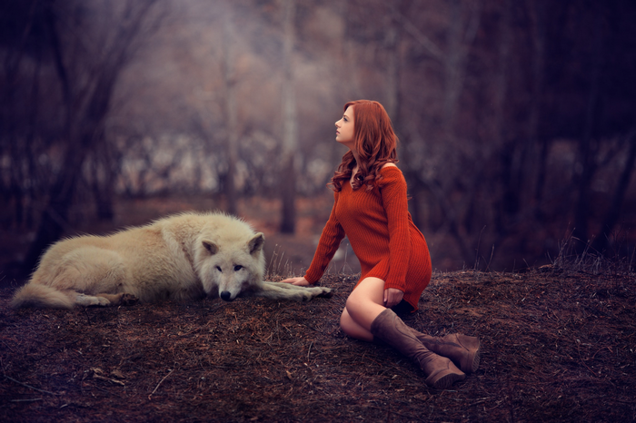 Woman and wolf in a dark forest