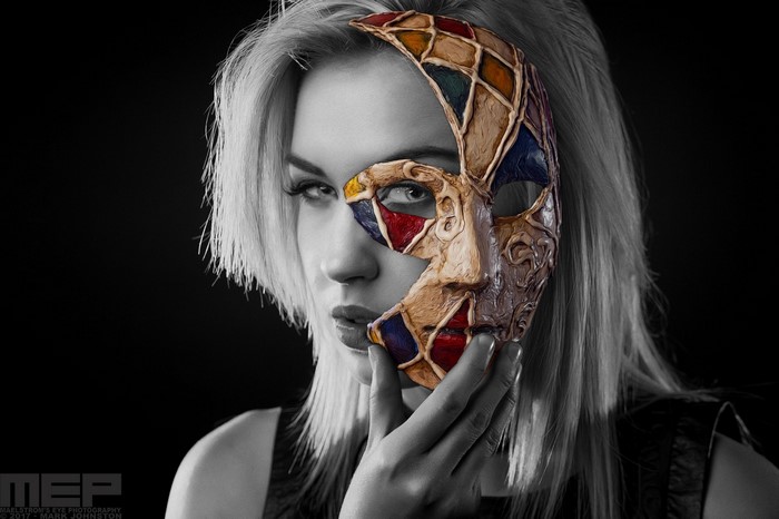 Woman wearing a colorful harlequin mask