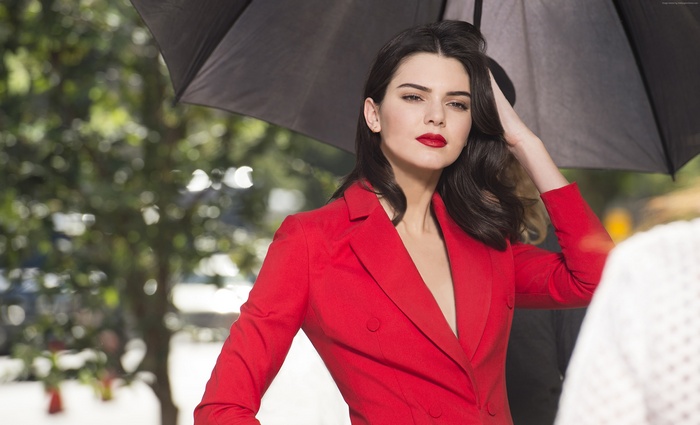 Kendall Jenner in red blazer under umbrella