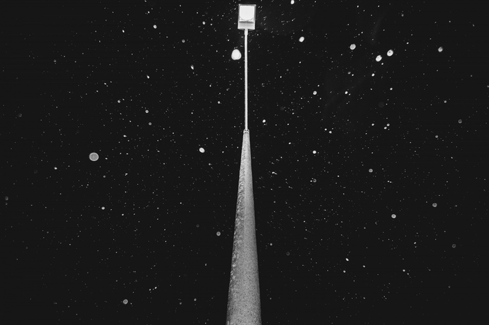 Street light in the night sky with snow