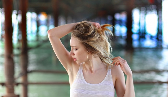 Woman with hands in her blonde hair