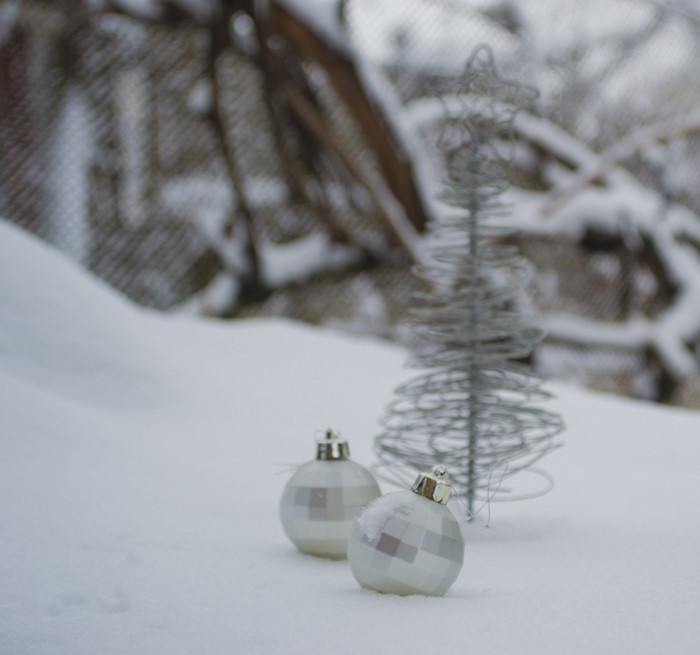 Christmas ornaments and tree in the snow