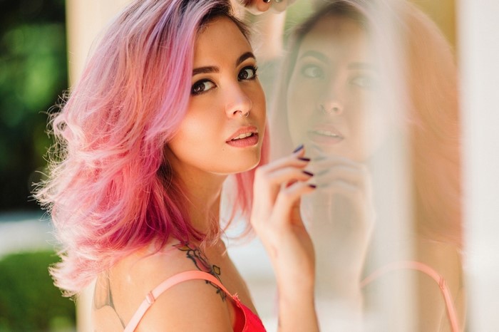 Woman with pink hair and tattoos