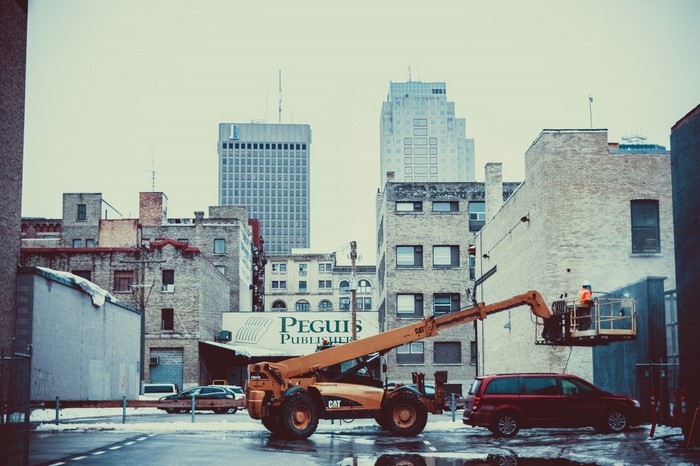 Construction vehicle and worker in downtown Winnipeg