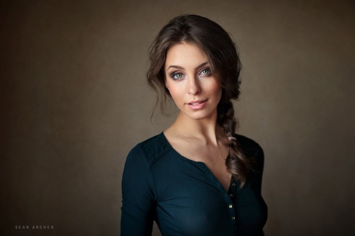 Woman with braided brown hair and green eyes, portrait