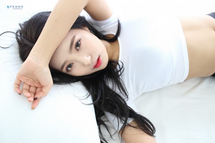 Brunette Woman in White Crop Top Lying Down