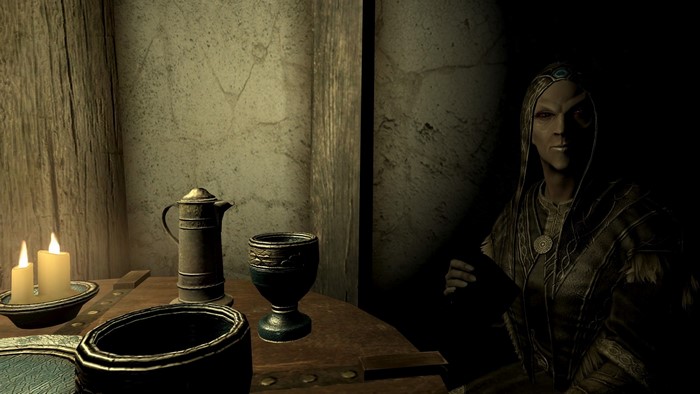 The Elder Scrolls V Skyrim screenshot with a woman and table setting
