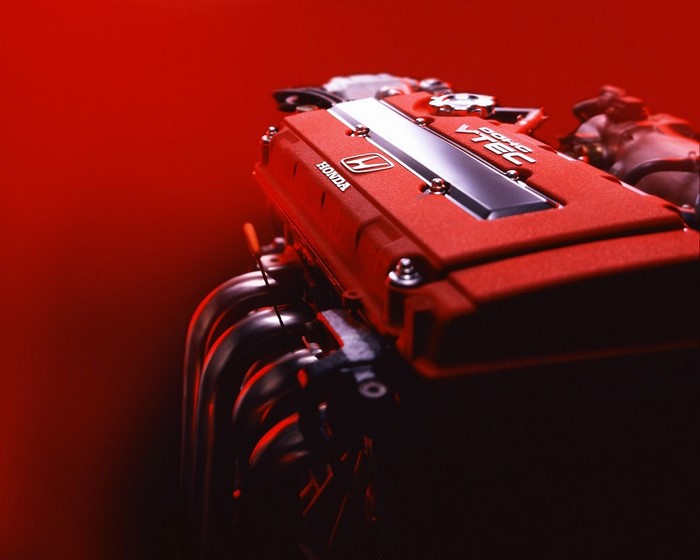 Red Honda VTEC engine with exhaust manifold