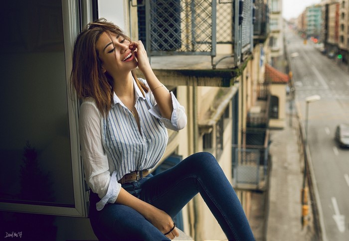 Smiling Woman Sitting by Window with Street View