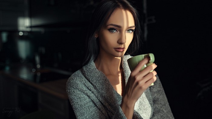 Woman in bathrobe holding a mug, photographed by Sergey Fat