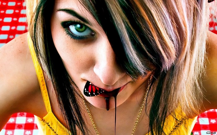 Woman with butterfly on mouth and dripping blood