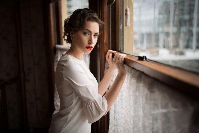 Woman in white dress by the window