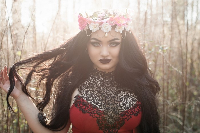 Woman with flower crown and dark makeup