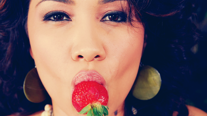 Woman eating a strawberry