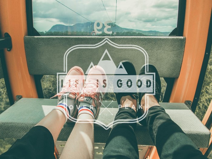 Couple in cable car with mountains view
