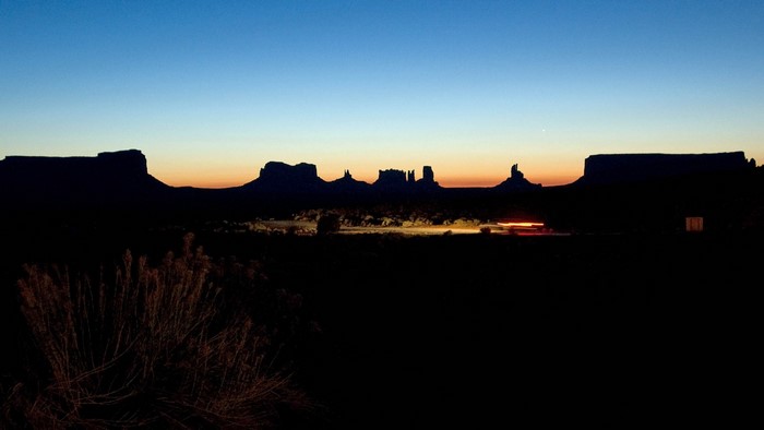 Monument Valley at dusk with car light trails