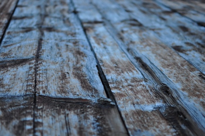 Close up of weathered blue and brown wooden planks