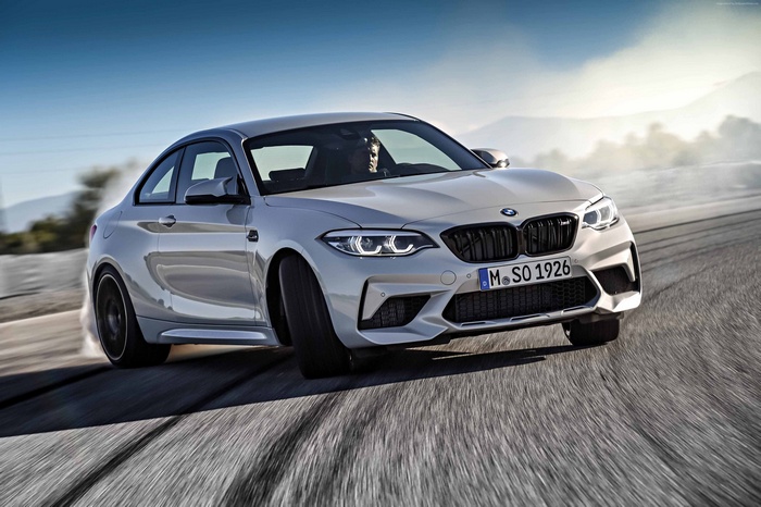 BMW M2 Competition drifting on a road