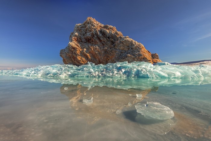 Rock formation on frozen Lake Baikal with ice shards