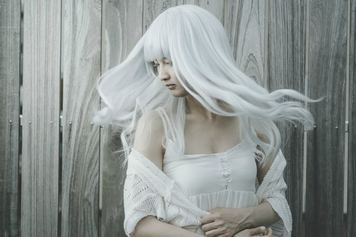 Woman with long white hair in a white dress